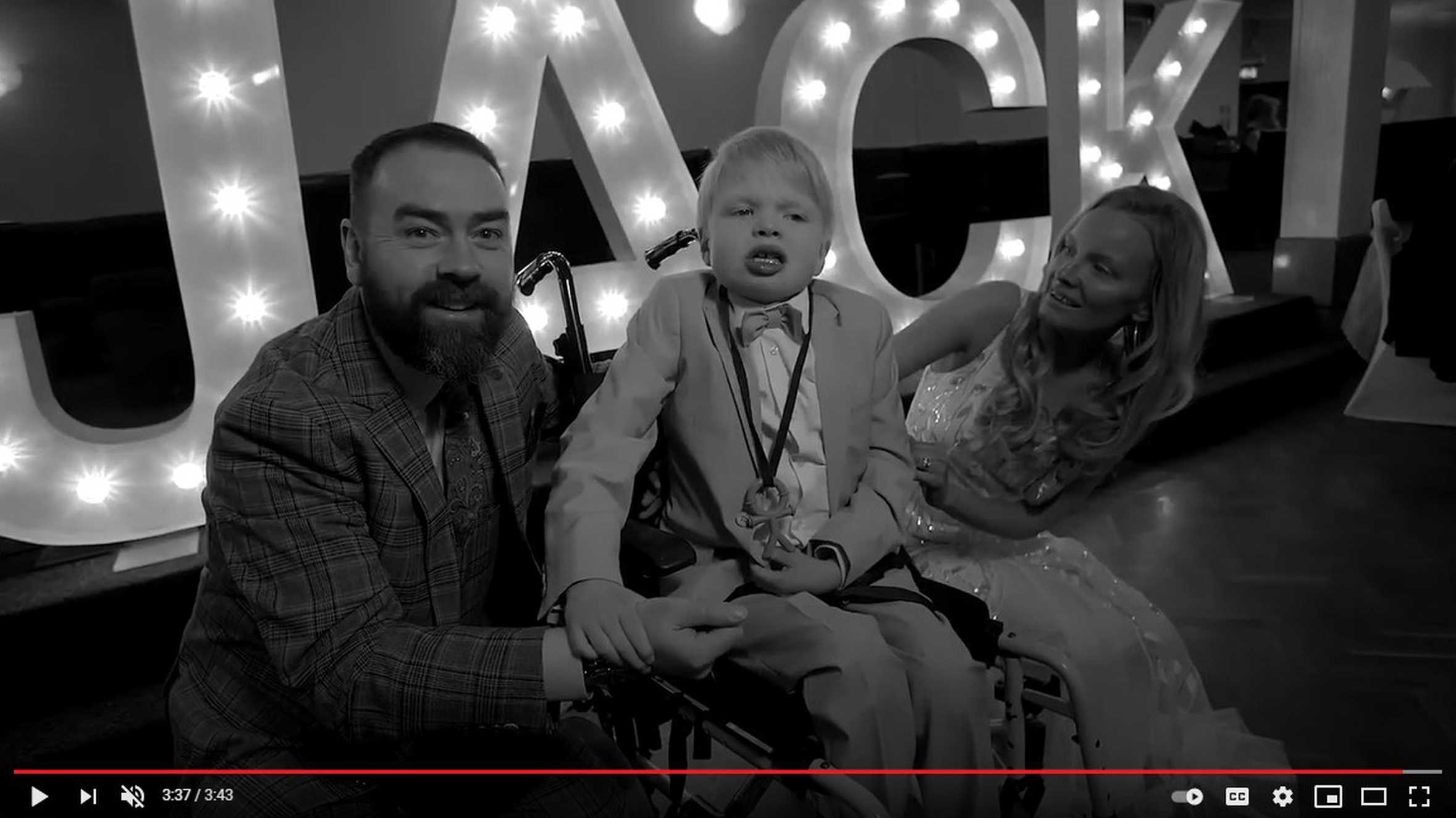 A still of Jack with his mum and dad, taken from the video of his wish.